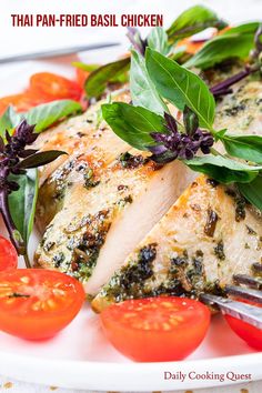 a white plate topped with chicken and tomatoes