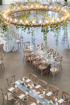 the tables are set up with place settings and flowers on them for an elegant dinner