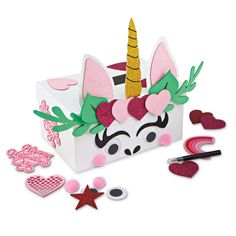 a unicorn shaped box filled with lots of crafting supplies