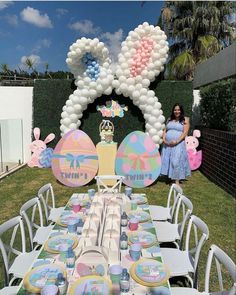 a table set up for a baby's first birthday party with balloons and decorations