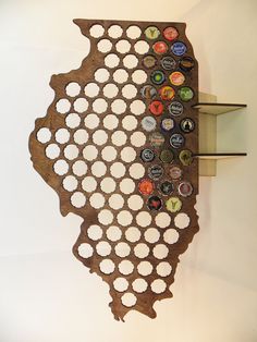 a wooden wall hanging with many different bottle caps on it