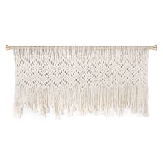 a white wall hanging with fringes on it