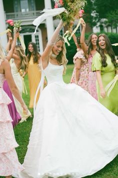 a bride and her bridal party throwing confetti on each other in the air