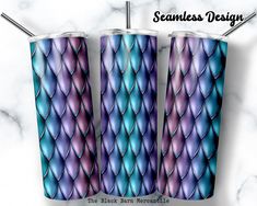 three stainless steel tumblers with blue and purple scales on them