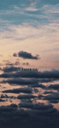 the words i love you are written in black on a cloudy sky at sunset or dawn