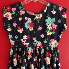 Adorable Hanna Andersson Floral Dress, Nice For Easter, Spring And Summer. Navy Blue Background With Floral Print, Short Sleeves, Buttons Down The Front Until Above The Waist Gathers. Appears To Be New Without Tags. 100% Cotton Size 12 (150 Cm) 58-62 In. 75-95 Lbs. Casual Sleeveless Floral Print Twirl Dress, Casual Short Sleeve Twirl Dress For Dress-up, Blue Floral Print Playtime Dress, Floral Print Short Sleeve Playwear Dress, Casual Dresses With Buttons For Playtime, Casual Blue Dress For Playtime, Casual Blue Dresses For Playtime, Cute Blue Dresses With Buttons, Cute Blue Dress With Buttons