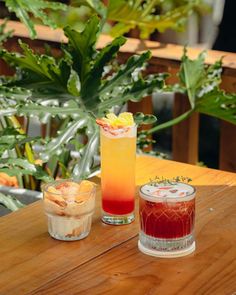 two drinks sitting on top of a wooden table