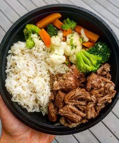 a bowl filled with meat, rice and veggies