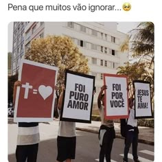 people holding up signs on the street with buildings in the backgrouns and palm trees