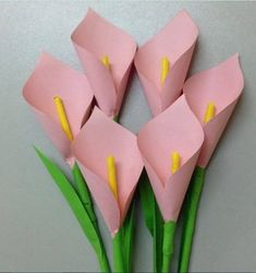 pink flowers with yellow stamens are arranged in the shape of folded origami