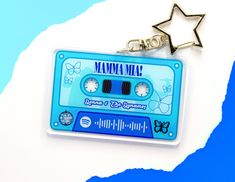 a keychain with a cassette tape on it and a star hanging from the front