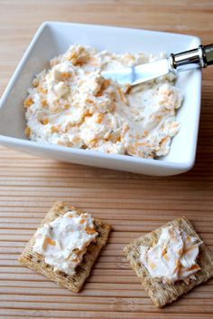 some crackers and dip in a bowl on a table