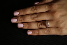 a woman's hand with a ring on it