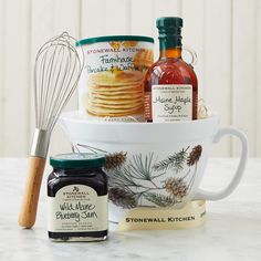 a bowl filled with cookies, jam and other items next to a whisk