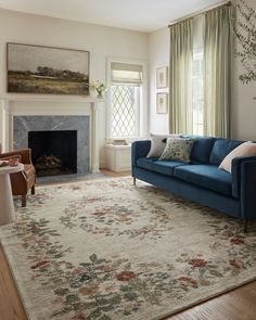 a living room filled with furniture and a fire place under a painting on the wall