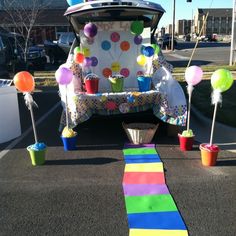 a car decorated with balloons and streamers on the road