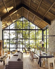 a living room filled with lots of furniture and a fire place in front of a large window