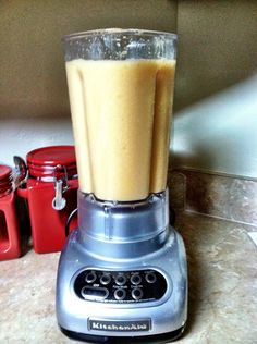 a blender filled with liquid sitting on top of a counter