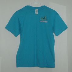 Margaritaville Landshark Surf Shack Atlantic City Double-Sided, Turquoise Colored T-Shirt. Brand New With $18.95 Price Tag And In Size Large. Other Approximate Measurements: 18" Pit To Pit, 18 1/2" Waist And 25" Length. Casual Blue Surfing Shirt, Light Blue Crew Neck Beach T-shirt, Casual Cotton T-shirt With Shark Design, Light Blue Crew Neck T-shirt For Beach, Summer Short Sleeve T-shirt With Shark Design, Casual Short Sleeve Shark Design Tops, Blue Short Sleeve Tops For Surfing, Casual Short Sleeve T-shirt With Shark Design, Turquoise Crew Neck T-shirt For Summer