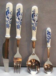 an assortment of spoons and forks with blue flowers on them