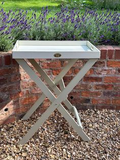 a white tray sitting on top of a wooden table in front of a brick wall