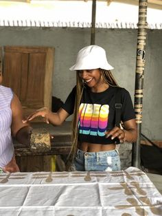 two women standing next to each other near a table