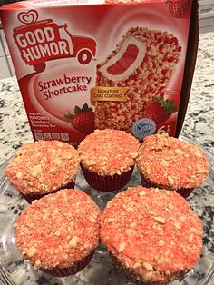 four strawberry shortcakes on a glass plate next to a bag of good humor