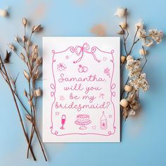 a greeting card with pink ink on white paper next to dried flowers and baby's breath