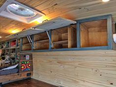 the inside of a truck with wooden walls and shelves