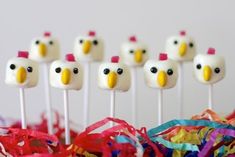 several marshmallows with fake birds on them