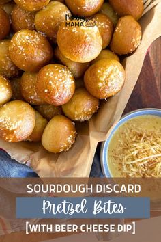 a basket filled with bread and cheese on top of a wooden table next to a bowl of grated cheese