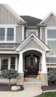 a house with gray siding and white trim on the front door is featured in this article