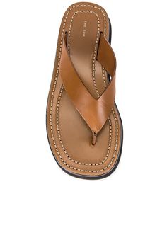 Find THE ROW Ginza Thong Sandals In Brown on Editorialist. The Row Ginza Thong Sandals in Brown Leather upper with rubber sole. Made in Italy. Approx 25mm/ 1 inch platform. Contoured footbed. Tonal stitching detail. TERX-WZ21. F1159-L52. About the designer: The Row was established in 2006 by industry icons Ashley Olsen and Mary-Kate Olsen. Named in reverence of London's Savile Row, the fashion house emulates the bespoke standards of exceptional fabrics, impeccable details, and precise tailoring. The Row Ginza, Latest Sandal, Low Heel Wedges, Mens Leather Sandals, Mary Kate Olsen, Leather Thong Sandals, Ashley Olsen, Leather Platform Sandals, Italy Fashion