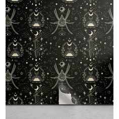 a black and gold wallpaper with stars, moon and sun designs on the background