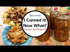 two jars filled with food sitting on top of a table next to plates and utensils