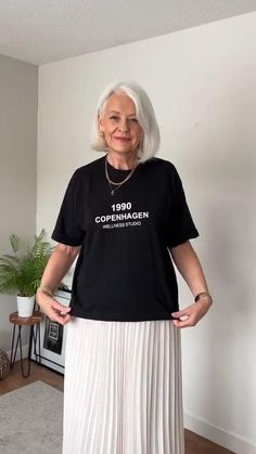 A simple #hack when your tucking black into cream or the tee is too bulky to tuck in! #fashionover50 #over50style #over60 #fashionhack #stylehack Autumn Casual Work Outfits Women, Top Ideas For Skirts, Rose Gold Satin Skirt Outfit, Tee Shirt With Skirt Outfit, Tucking Shirt Into Skirt, How To Style A T Shirt With A Skirt, Style After 40 What To Wear, Styling Black Pleated Skirt, How To Style Shirt With Skirt