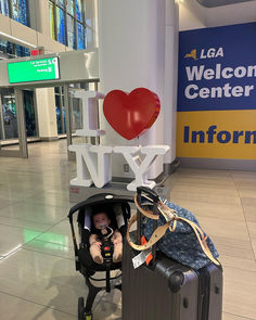 a baby in a stroller at an airport