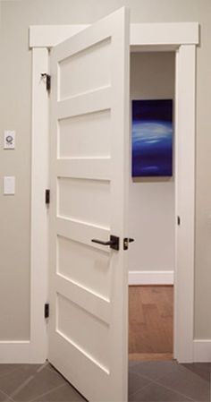 an open white door leading to a bathroom