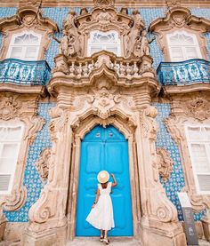 a woman standing in front of a blue door