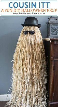 a hat and sunglasses are on top of a long, shaggy wig in front of a dresser