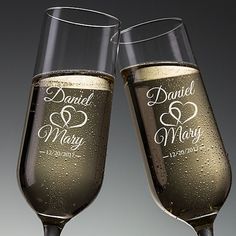 two champagne flutes with personalized names and hearts on the side, sitting next to each other