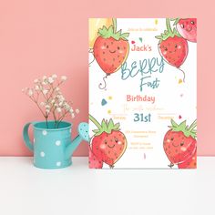 a birthday card with strawberries on it next to a watering can