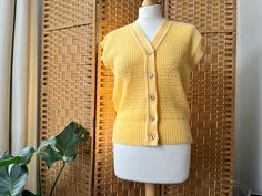 "A really sweet pastel yellow sleeveless cardi, lovely as a layer & fab on its own too. Bust measures approx  up to 38\", 31\" shoulder to hem. Excellent condition" Retro V-neck Vest For Spring, Vintage V-neck Vest For Spring, Casual Yellow V-neck Vest, Spring V-neck Retro Vest, Retro V-neck Spring Vest, Spring Knit Sweater Vest With Buttons, Fitted Vintage Summer Cardigan, Vintage Fitted Summer Cardigan, Yellow V-neck Vest For Spring