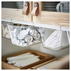 the kitchen drawer is organized with clear containers and utensils