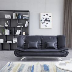 a modern living room with black leather furniture