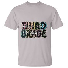 a grey t - shirt with the words third grade printed in multicolored letters