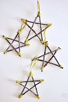 four sticks are arranged in the shape of an eight - pointed star with yellow string