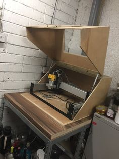 an open box sitting on top of a table next to a white brick wall in a room