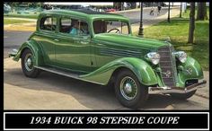 an old green car is parked on the street