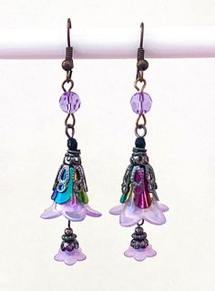 These wizard hat dangle earrings are handmade by myself.  The earrings have crystal accents, and the wires are brass. If you have any questions, please ask.  If something wouldn't be right it would be by accident.  Please let me know so I can help you and make it right.  I want you to be happy! It's best to store the item in a plastic bag to keep it shiny.  I am not sure of the exact metal content of the components. Thanks so much for looking! Whimsical Dangle Flower Earrings, Adjustable Bohemian Earrings With Bead Caps, Lavender Adjustable Dangle Beaded Earrings, Lavender Beaded Dangle Earrings, Whimsical Beaded Drop Earrings, Bohemian Pink Earrings With Bead Caps, Whimsical Adjustable Beaded Dangle Earrings, Handmade Adjustable Lavender Beaded Earrings, Handmade Adjustable Lavender Earrings